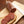 Slices of Mettwurst on a bread, with the log and knife next to it on a cutting board.