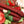 Bloody Mary Snack Sticks laying on a bed of tomatoes, garlic, and other vegetables.